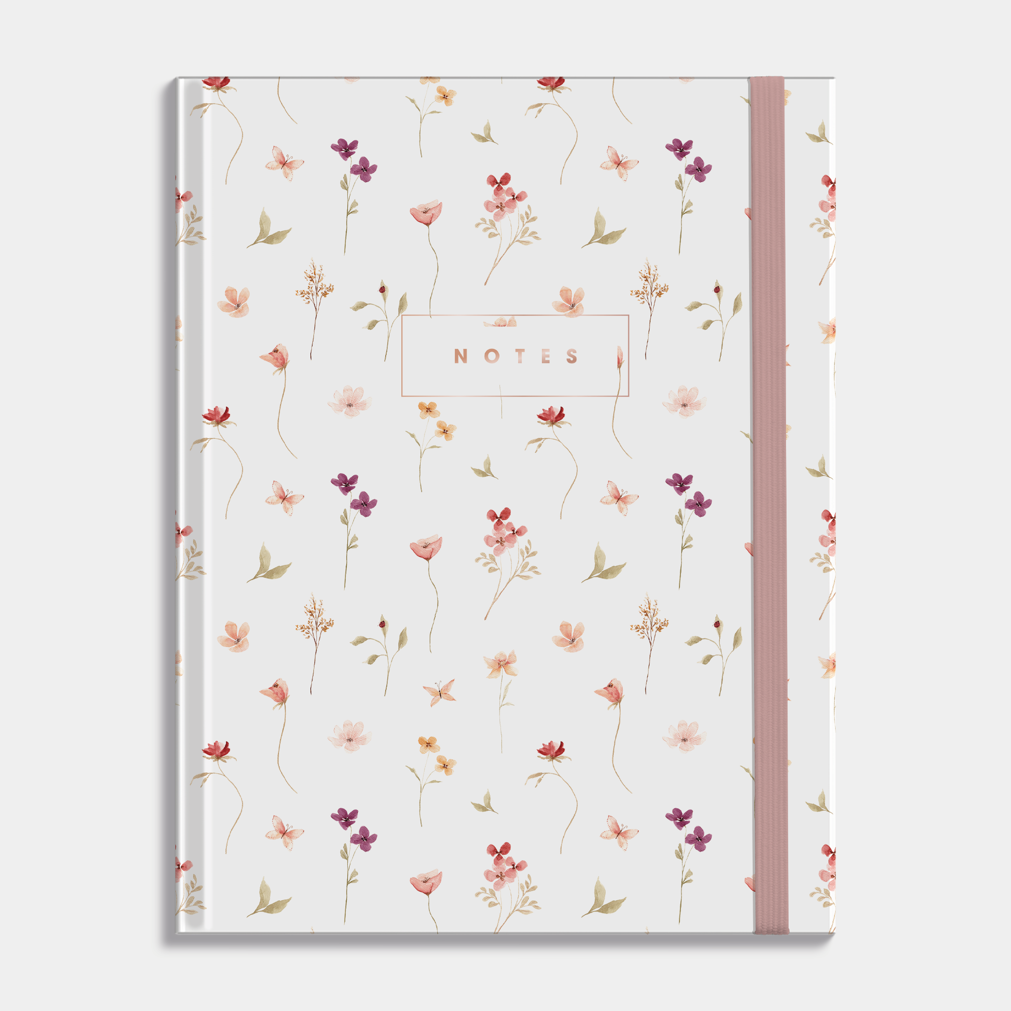 Notebook with delicate floral design in pastel colours on a white background.