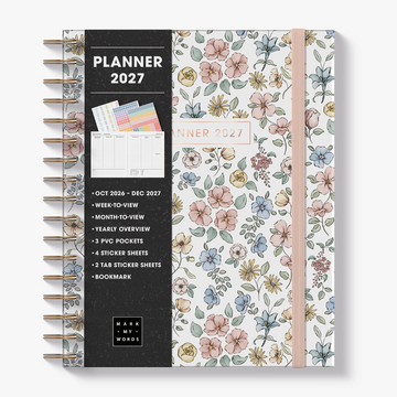 Spiral-bound luxury weekly planner 2027 in the A5+ size featuring small flowers in pastel shades – front view with informative paper wrap.